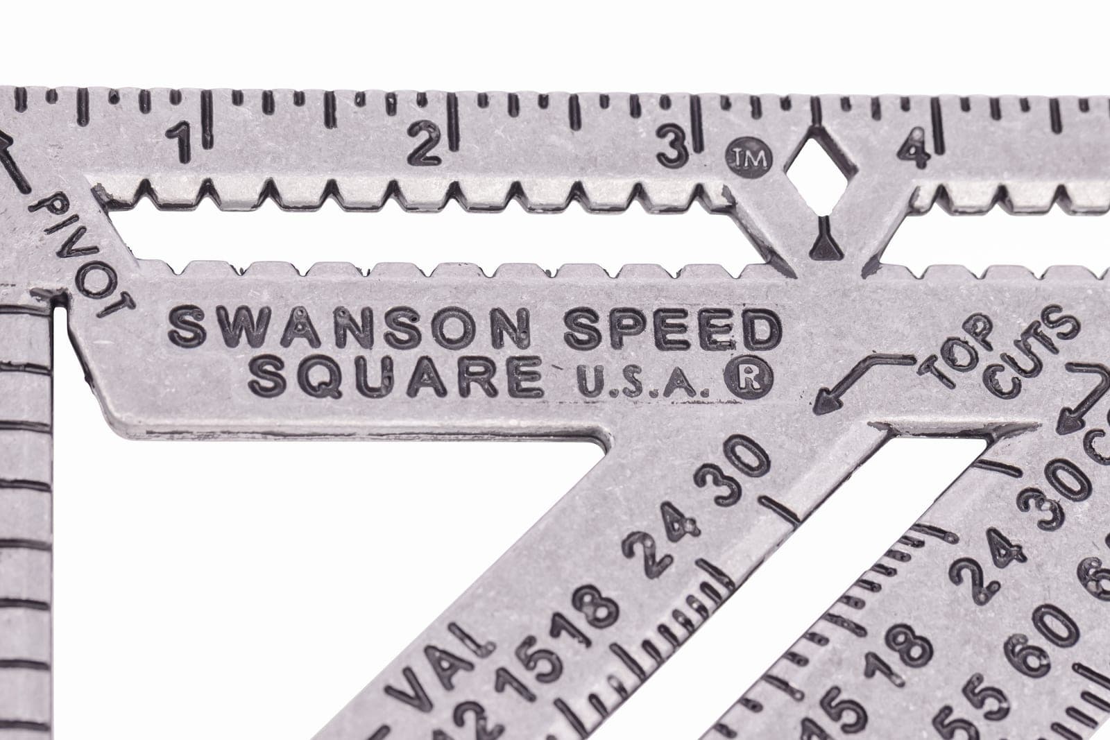 Macro close-up of the front face of a Swanson Speed® Square PRO showing the 2× longer scribe bar, the 1-4 in. graduations, the SWANSON SPEED SQUARE U.S.A. brand mark, and the Diamond™ cut-out at the 3 in. mark.