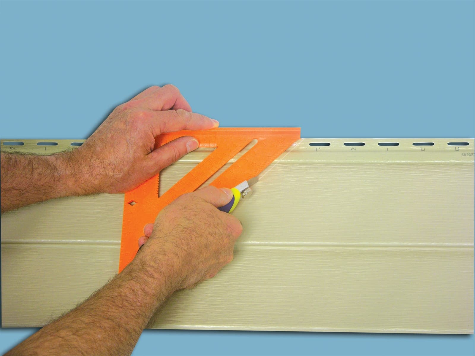 A Swanson Speedlite® Square in use on horizontal siding, marking a layout line for a cut.
