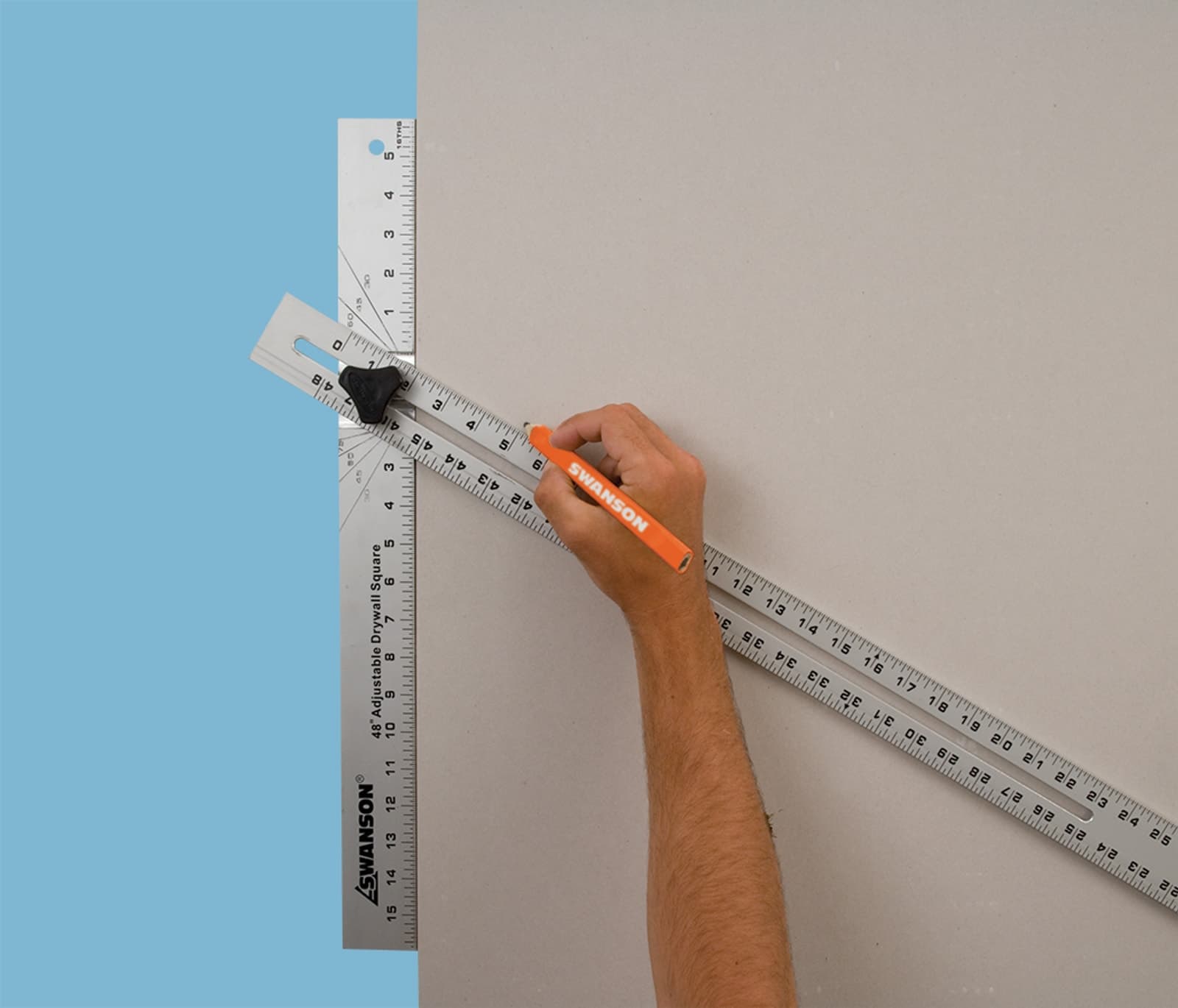 A drywaller using the Swanson AD124 on a drywall sheet to mark and cut along the blade.