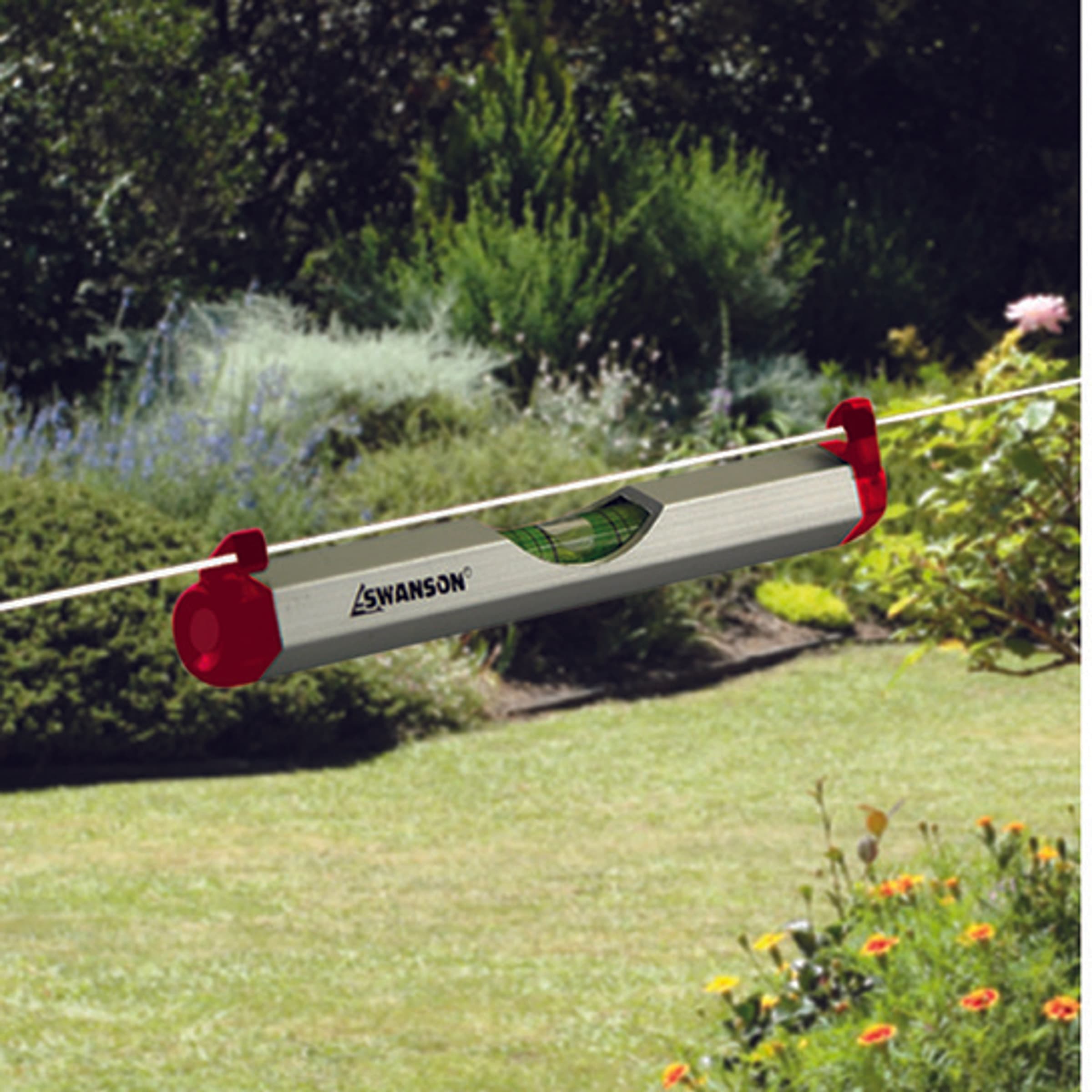 A trades pro using the Swanson LLA001 Line Level hung from a string line on a job site.