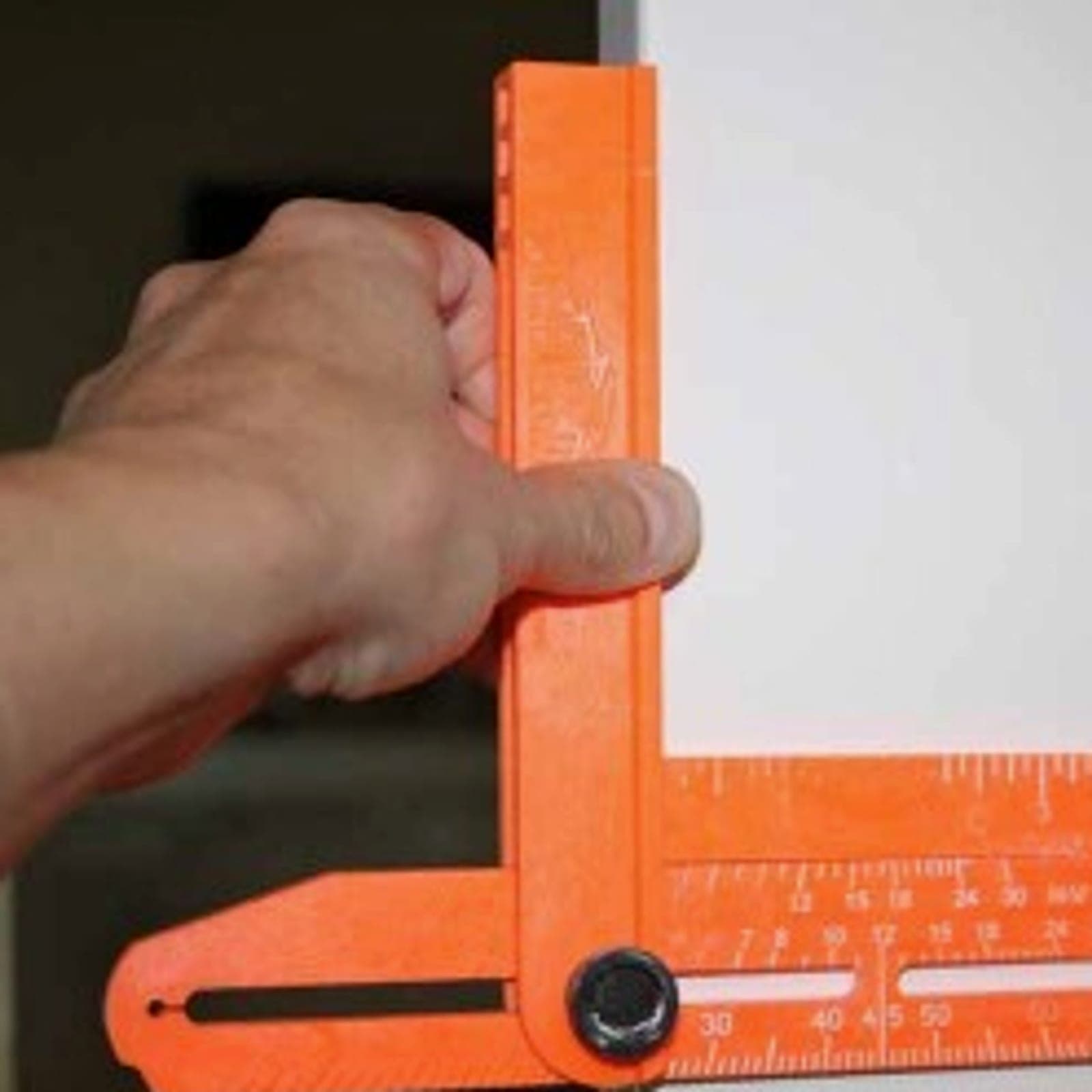 A Swanson Speed® Bevel being used on a door frame to scribe a trim layout line.