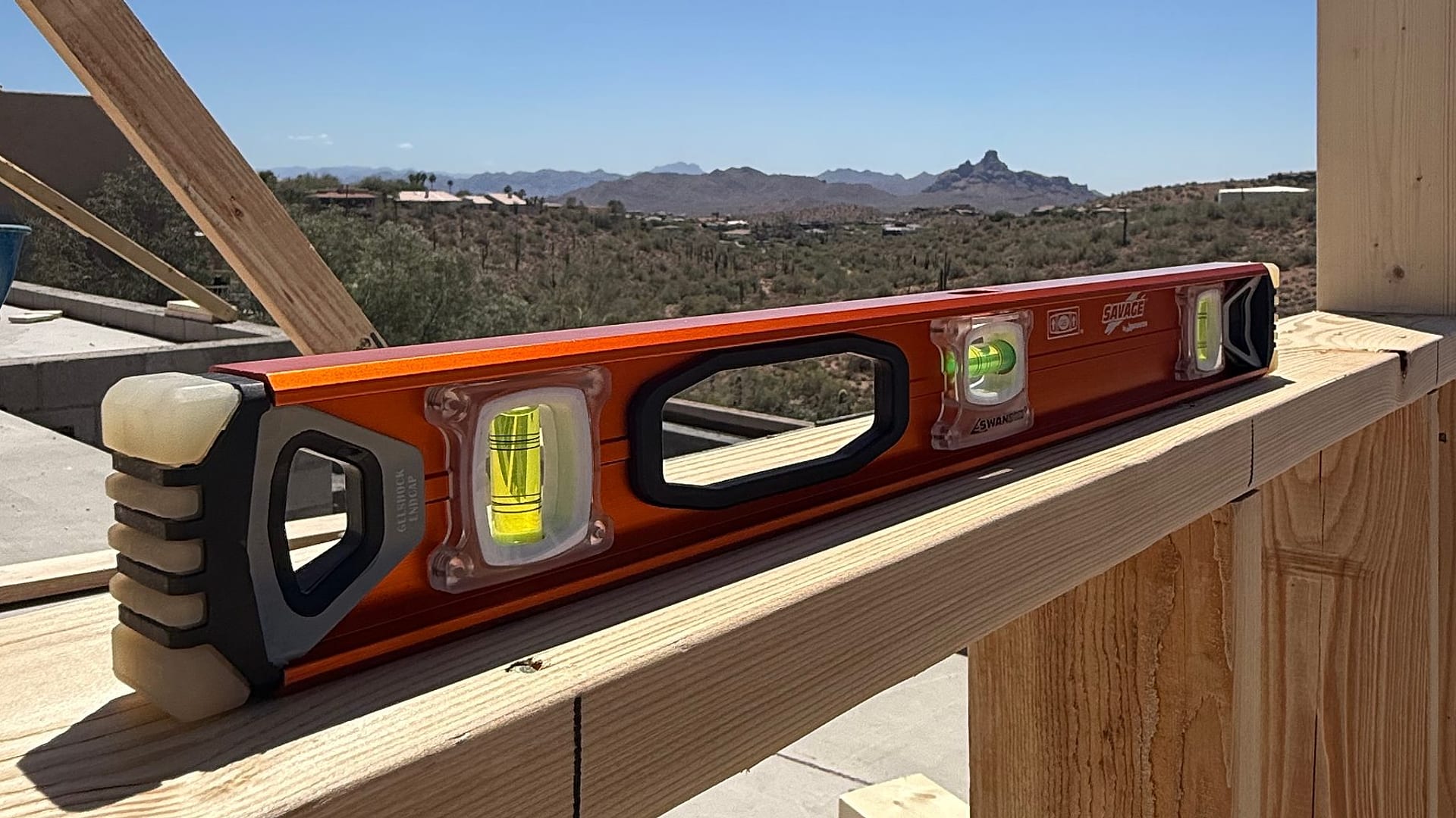 A 24-inch Savage™ I-Beam Level resting on a header against the Arizona sky.